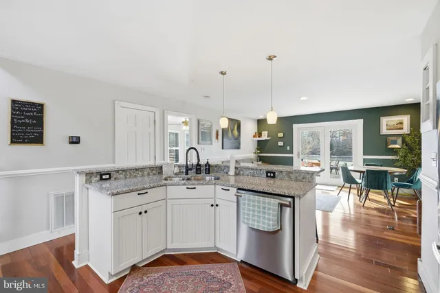 a kitchen with stainless steel appliances granite countertop a sink and cabinets