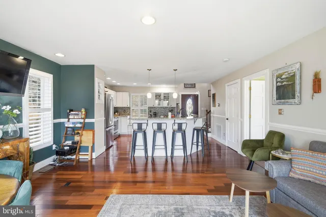 a living room with furniture wooden floor and a table