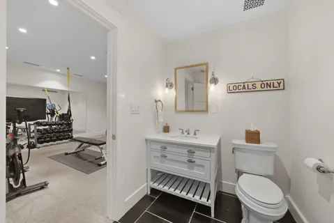a kitchen with white cabinets and sink
