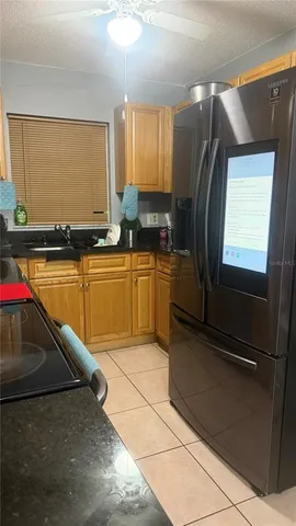 a kitchen with stainless steel appliances granite countertop a refrigerator and a stove