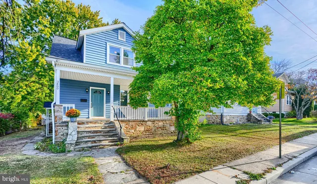 a view of a house with a yard and tree s
