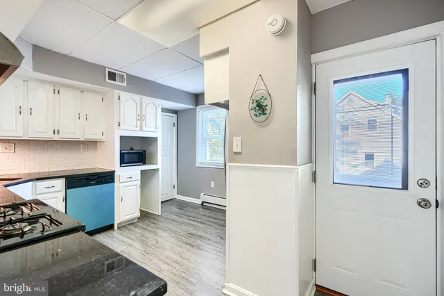 a kitchen with stainless steel appliances a refrigerator and a stove top oven