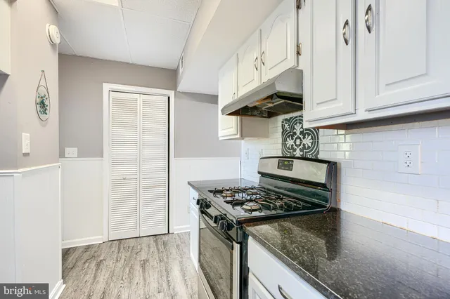 a kitchen with stainless steel appliances granite countertop a stove and a sink