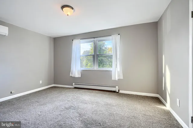 an empty room with a empty space and windows