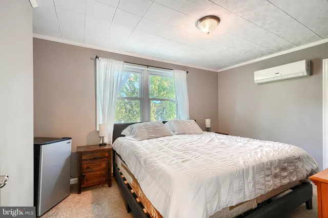 a bedroom with a bed and a window