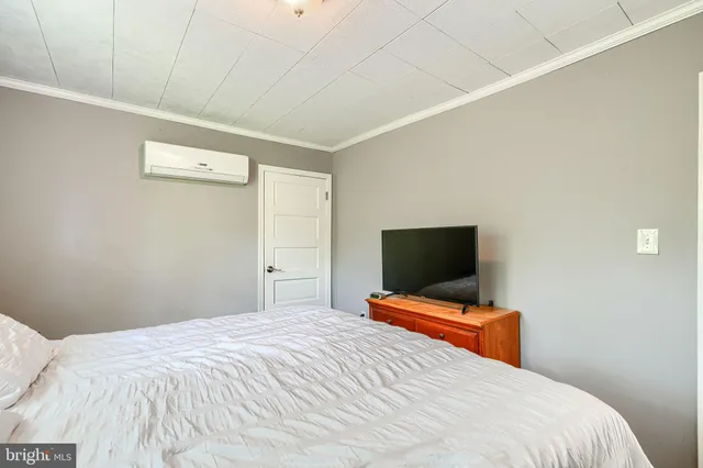 a bedroom with a bed and a tv