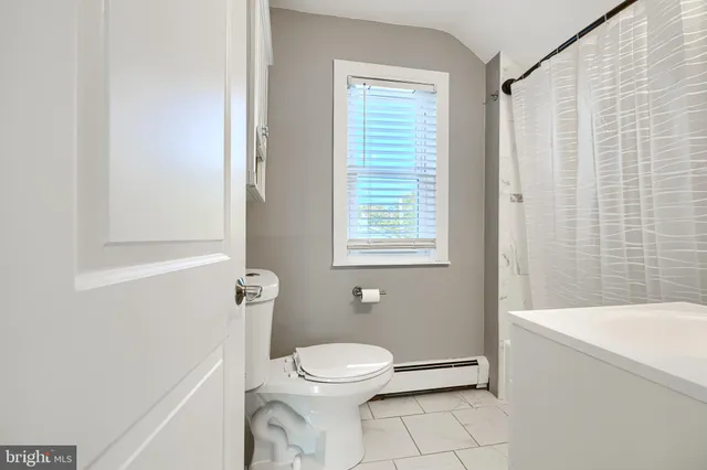 a bathroom with a toilet a sink and a shower