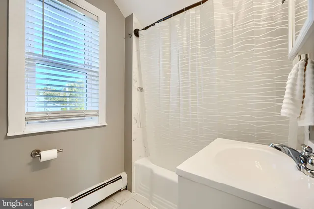 a bathroom with a sink a bath tub and a shower