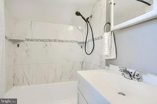 a bathroom with a sink a mirror and a shower