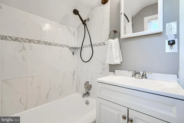 a bathroom with a sink a mirror and a shower