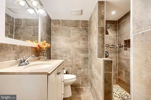 a bathroom with a sink toilet and shower