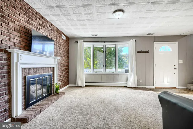 a view of livingroom with furniture and a fireplace