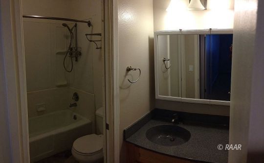 1224 North Erwin Street Ridgecrest, CA 93555 - Photo 13 of 30 a bathroom with a shower a toilet and a sink
