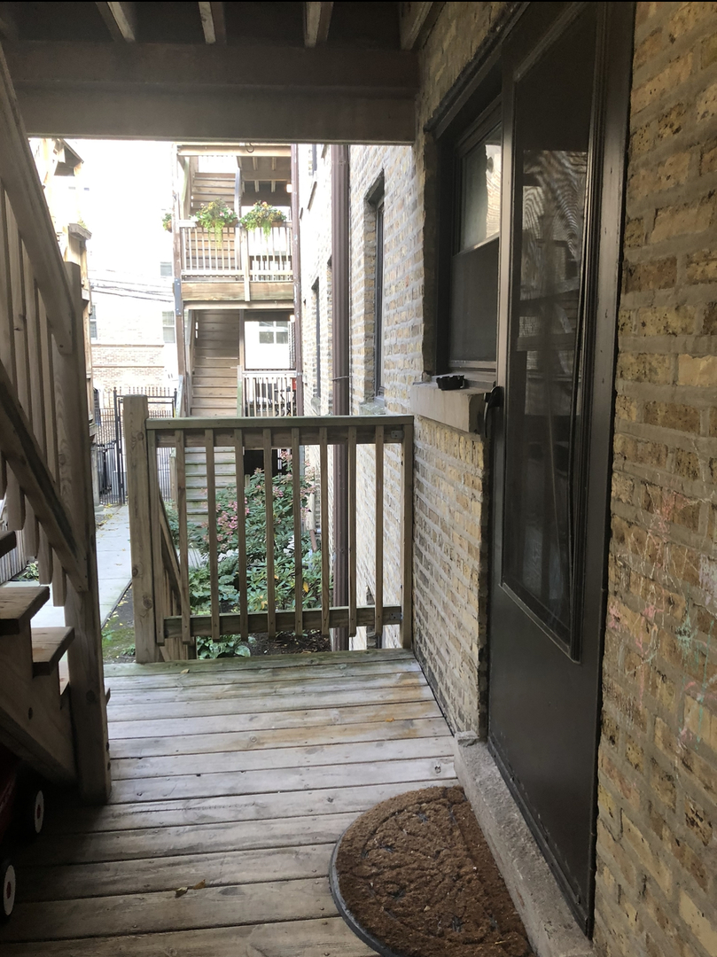 7425 North Sheridan Road, Unit 1E Chicago, IL 60626 - Photo 26 of 31 a view of balcony and floor to ceiling window wooden floor