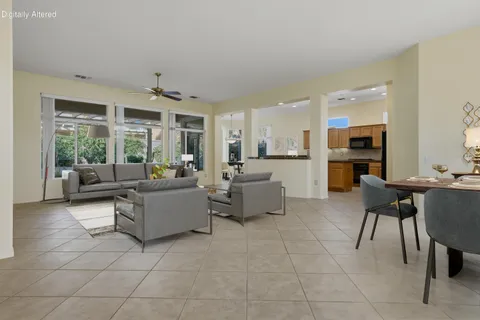 a living room with furniture a dining table and a fireplace