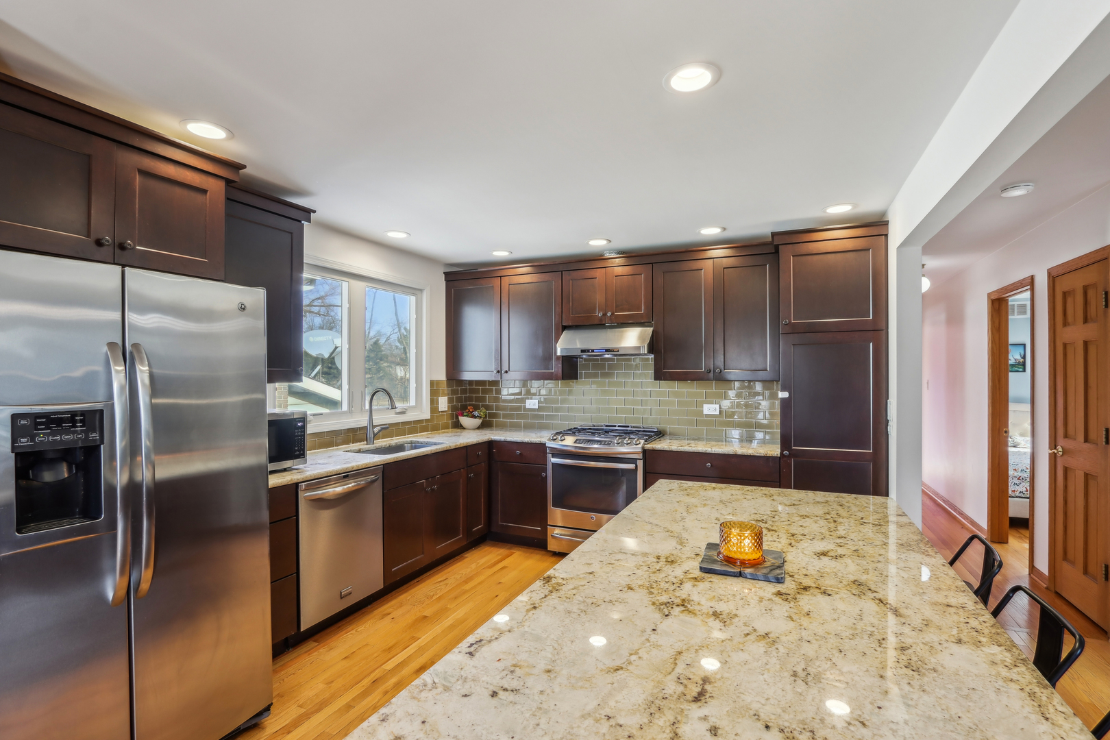 1925 Briarcliffe Boulevard Wheaton, IL 60189 - Photo 14 of 46 a large kitchen with kitchen island a large counter top stainless steel appliances and cabinets