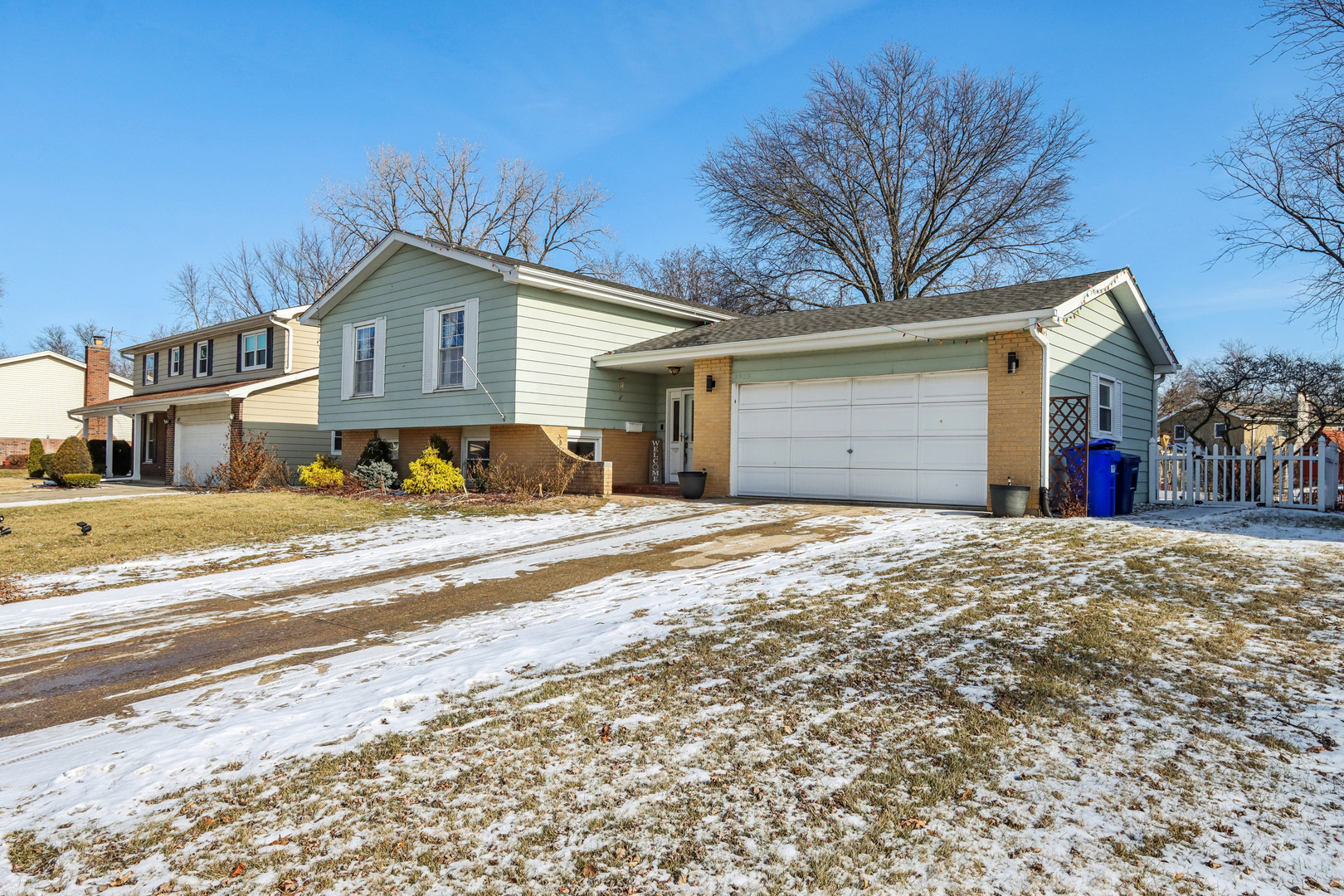 1925 Briarcliffe Boulevard Wheaton, IL 60189 - Photo 2 of 46 a front view of a house with a yard