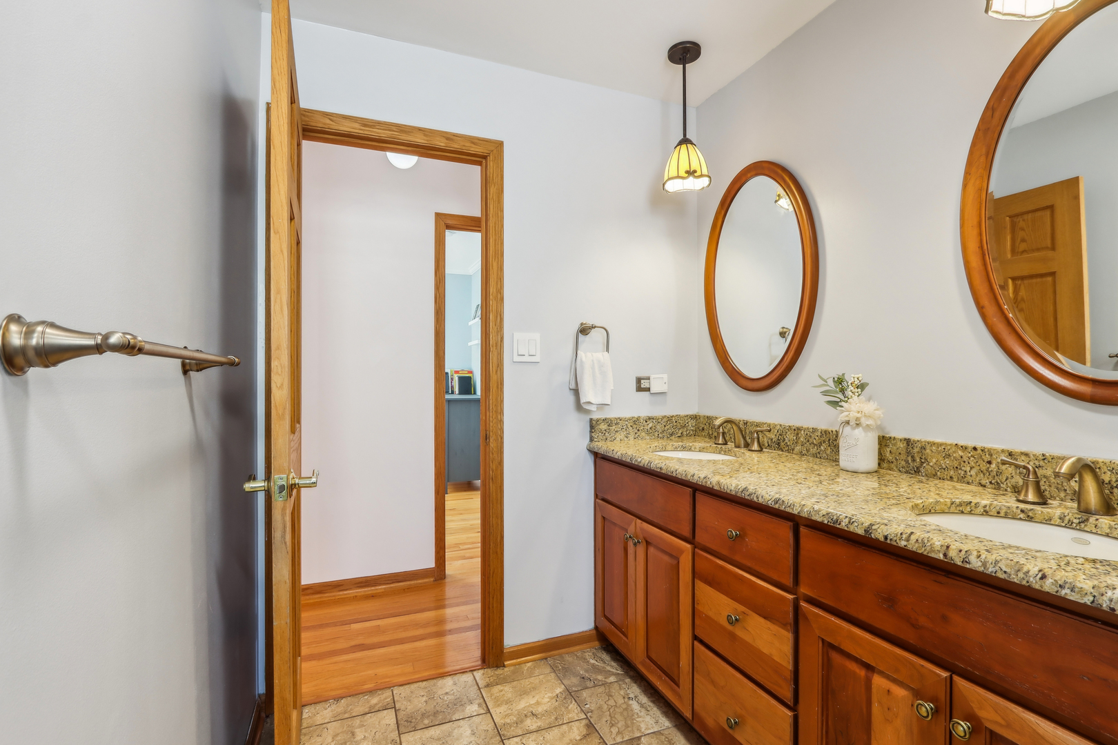 1925 Briarcliffe Boulevard Wheaton, IL 60189 - Photo 21 of 46 a bathroom with a granite countertop sink a mirror and a shower
