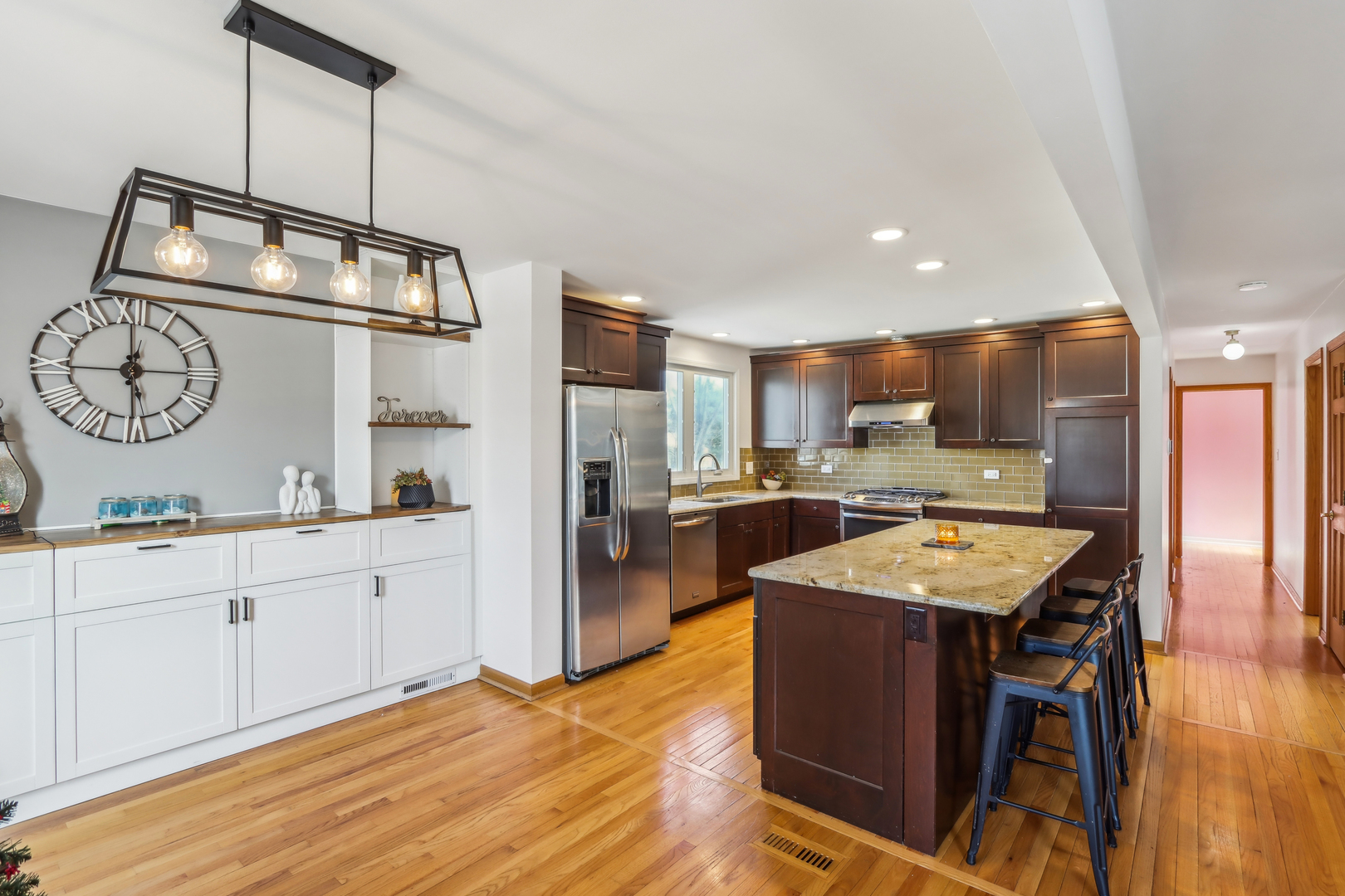 1925 Briarcliffe Boulevard Wheaton, IL 60189 - Photo 10 of 46 a kitchen with stainless steel appliances granite countertop a sink refrigerator stove and microwave