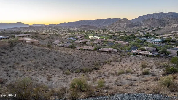 a view of a lush green hillside and houses