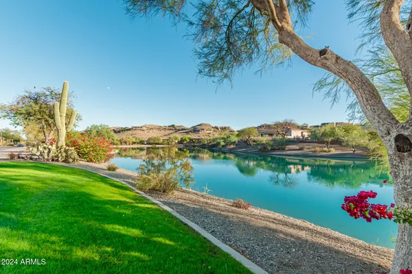 a view of swimming pool with lawn chairs and a yard