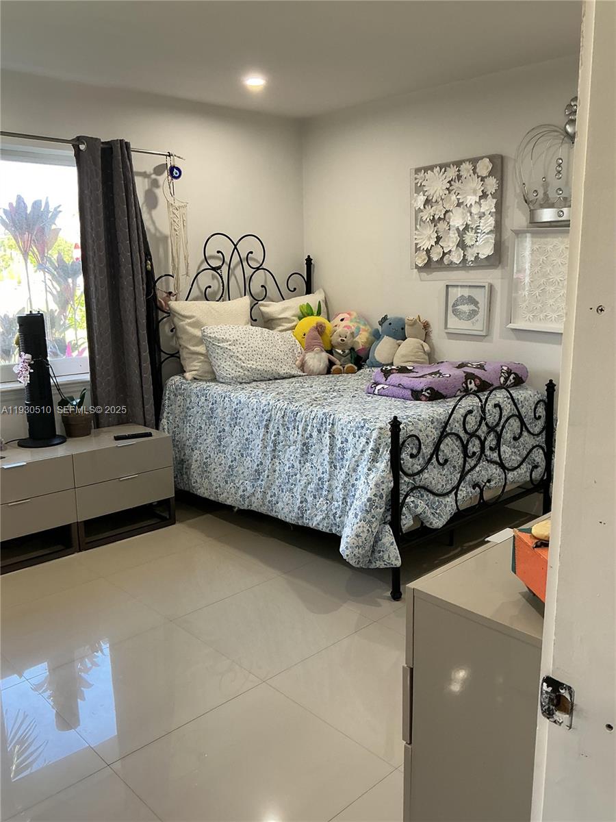 9700 Southwest 189th Street Cutler Bay, FL 33157 - Photo 14 of 21 a bedroom with bed and window