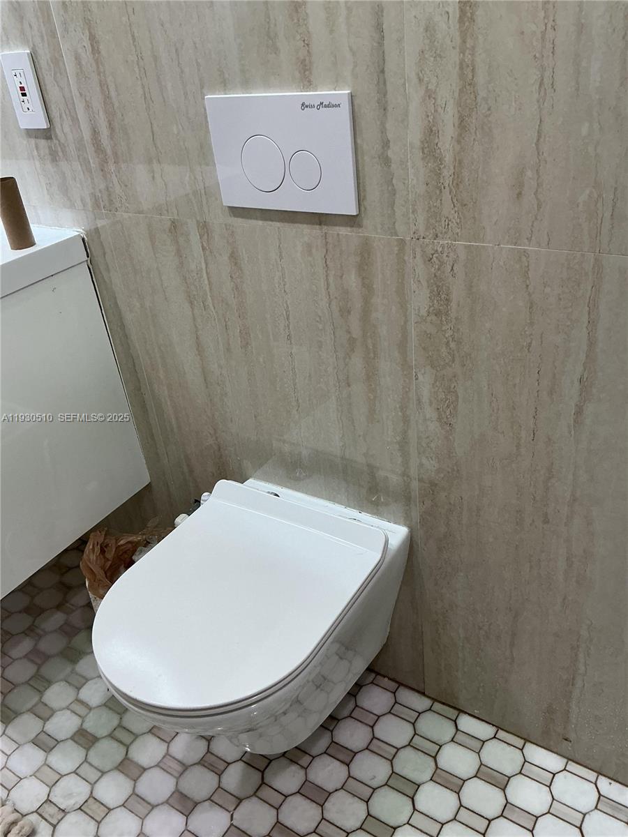 9700 Southwest 189th Street Cutler Bay, FL 33157 - Photo 15 of 21 a bathroom with a white toilet and a sink