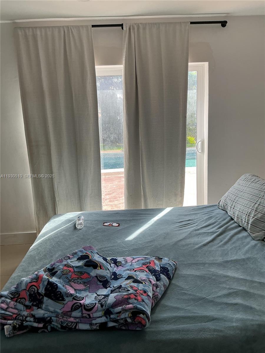 9700 Southwest 189th Street Cutler Bay, FL 33157 - Photo 18 of 21 a bedroom with a bed and a window