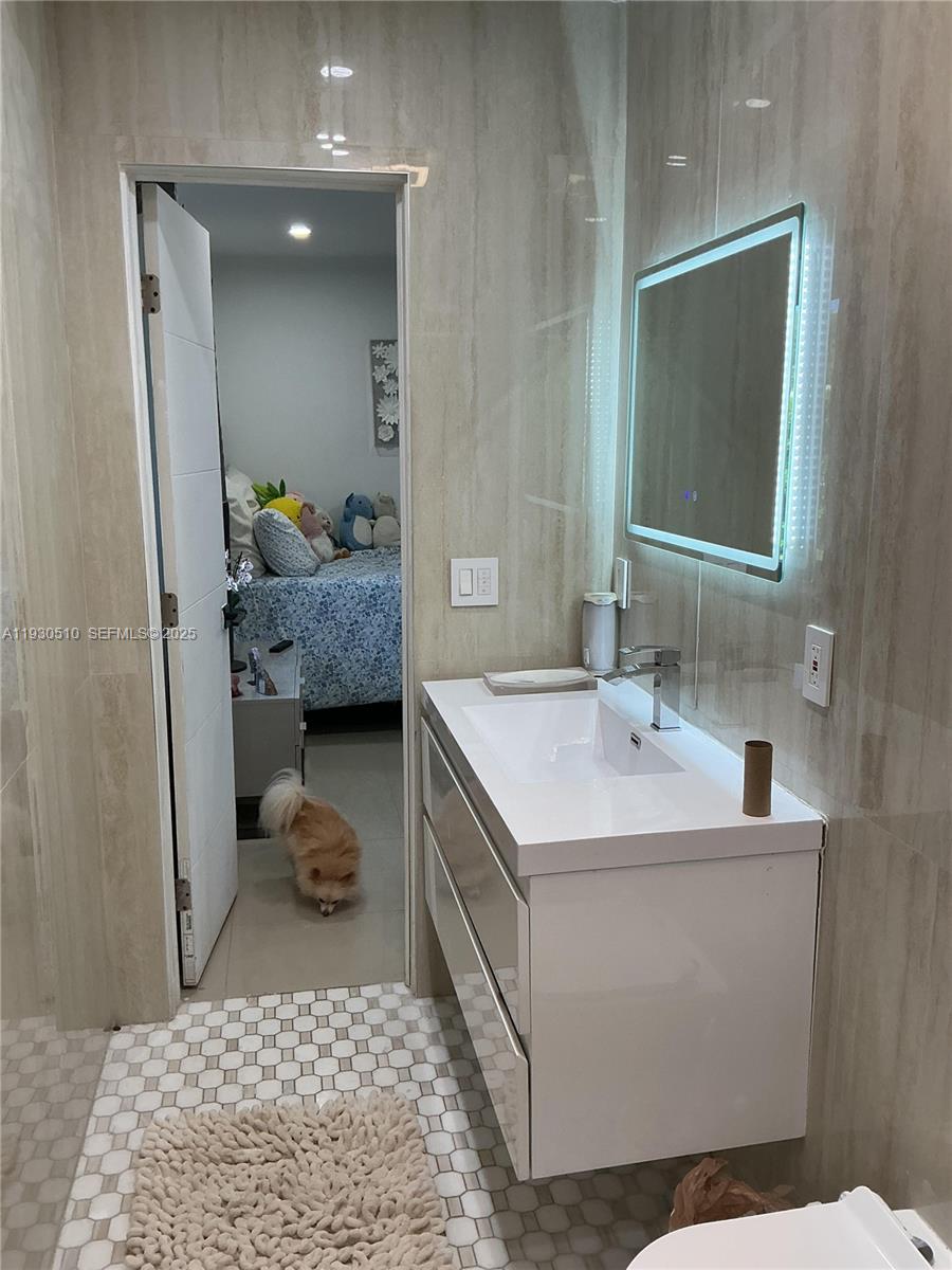 9700 Southwest 189th Street Cutler Bay, FL 33157 - Photo 10 of 21 a en suite bathroom with a sink and a mirror