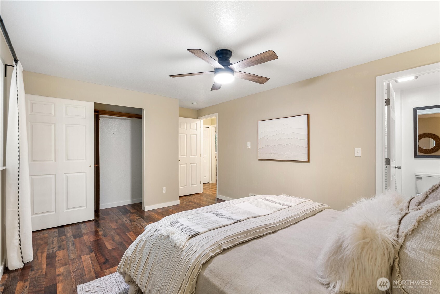 24711 Florence Acres Road Monroe, WA 98272 - Photo 19 of 33 a bedroom with a large bed and a chandelier