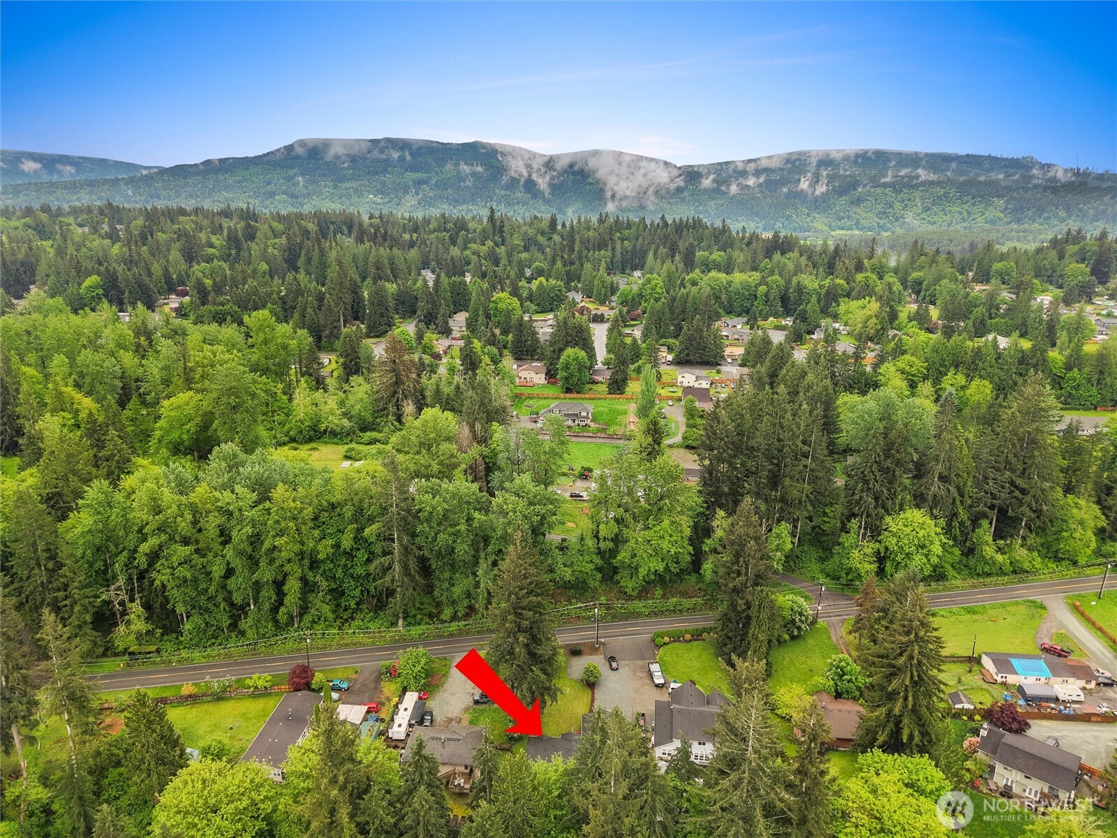 24711 Florence Acres Road Monroe, WA 98272 - Photo 27 of 33 a view of a lush green hillside and a houses