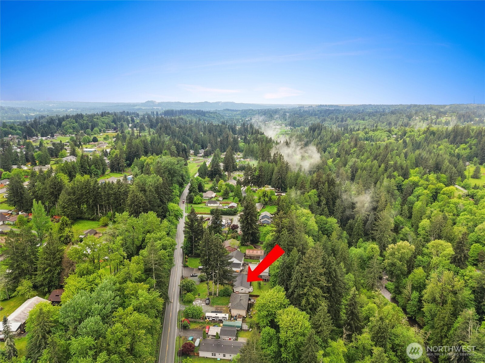 24711 Florence Acres Road Monroe, WA 98272 - Photo 28 of 33 a view of a city and lush green forest
