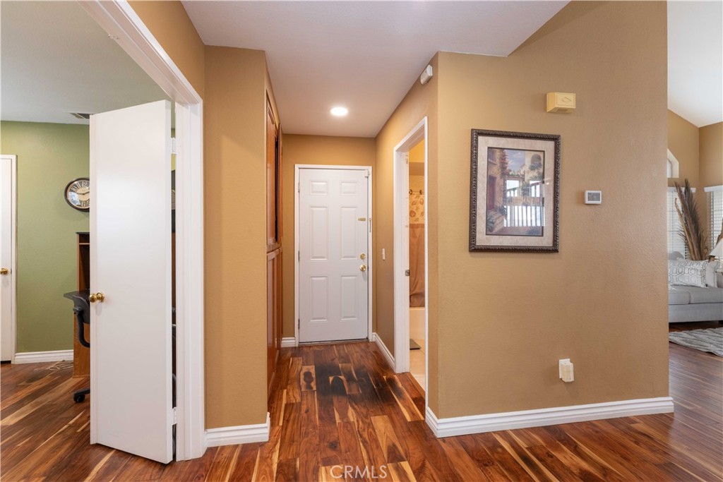 11541 Plane Tree Road Fontana, CA 92337 - Photo 11 of 33 a view of a hallway with wooden floor and staircase