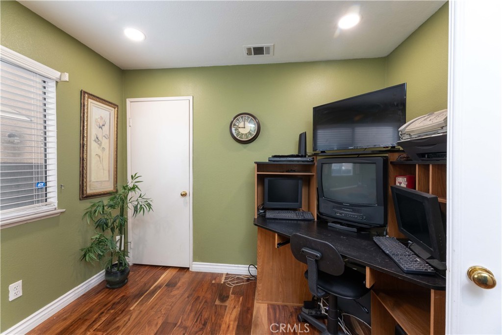 11541 Plane Tree Road Fontana, CA 92337 - Photo 13 of 33 a view of a workspace with furniture and wooden floor