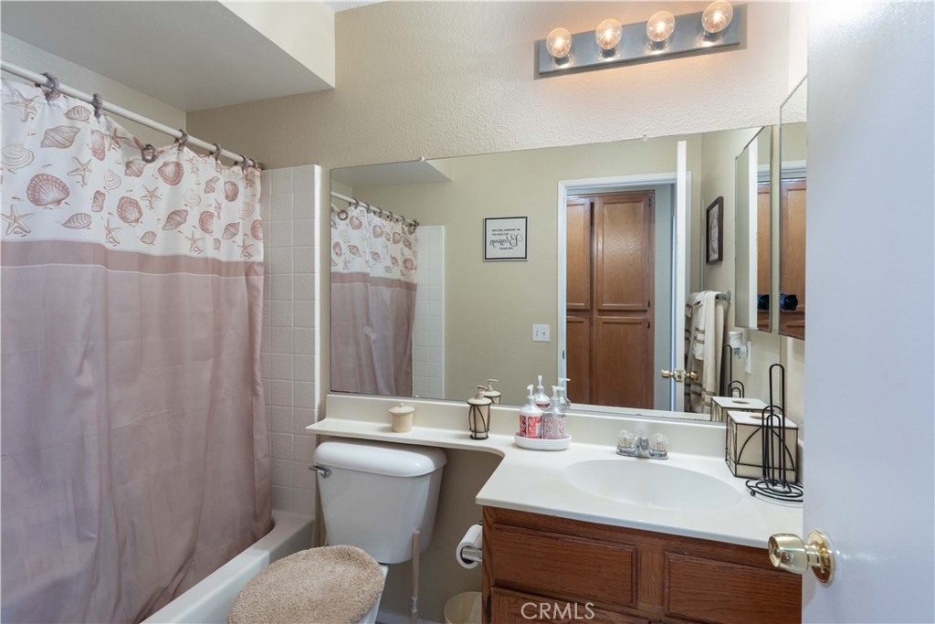 11541 Plane Tree Road Fontana, CA 92337 - Photo 14 of 33 a bathroom with a sink toilet and shower