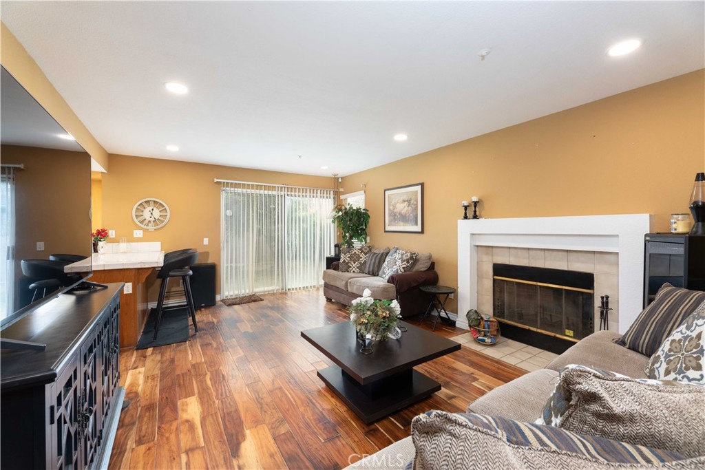 11541 Plane Tree Road Fontana, CA 92337 - Photo 16 of 33 a living room with furniture and a fireplace