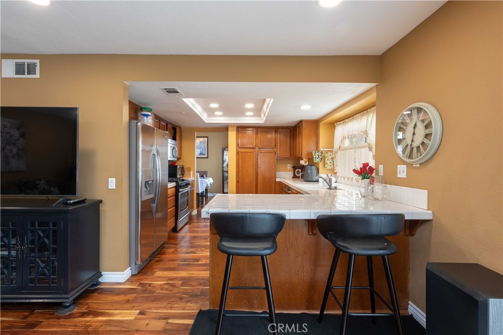 11541 Plane Tree Road Fontana, CA 92337 - Photo 20 of 33 a view of kitchen with cabinets and wooden floor