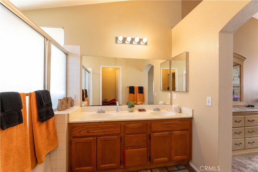 11541 Plane Tree Road Fontana, CA 92337 - Photo 26 of 33 a bathroom with a double vanity sink and mirror