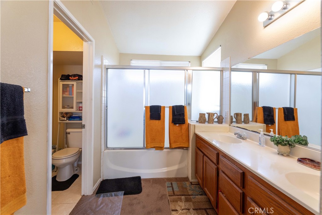 11541 Plane Tree Road Fontana, CA 92337 - Photo 27 of 33 a bathroom with a double vanity sink toilet and shower