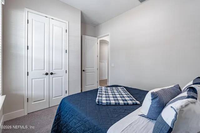 a view of a swimming pool with outdoor seating and yard in back