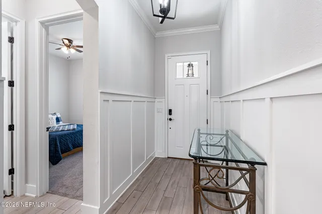 a living room with furniture kitchen view and a flat screen tv