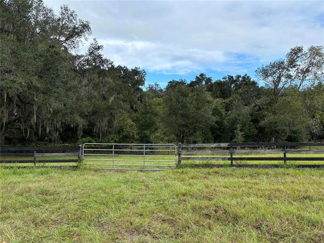 a view of outdoor space with deck and trees