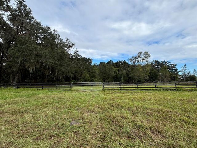 a view of field with trees in the background