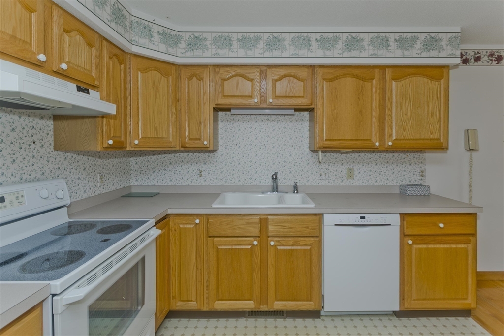 86 Beveridge Boulevard, Unit 86 Westfield, MA 01085 - Photo 5 of 16 a kitchen with a sink a stove and cabinets