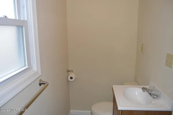 a bathroom with a sink mirror and toilet
