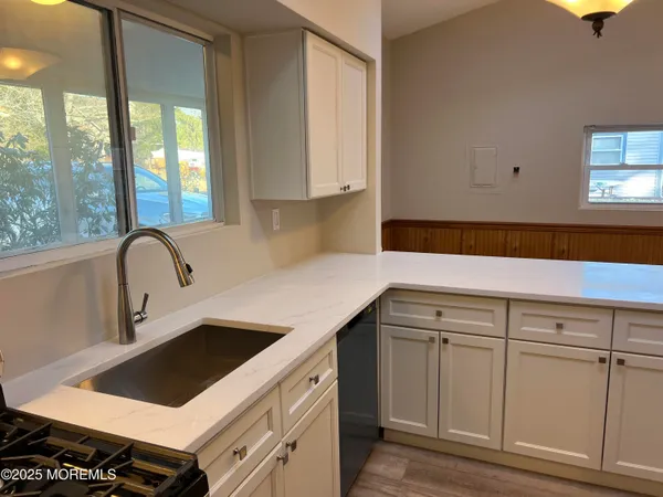 a kitchen with a sink and cabinets