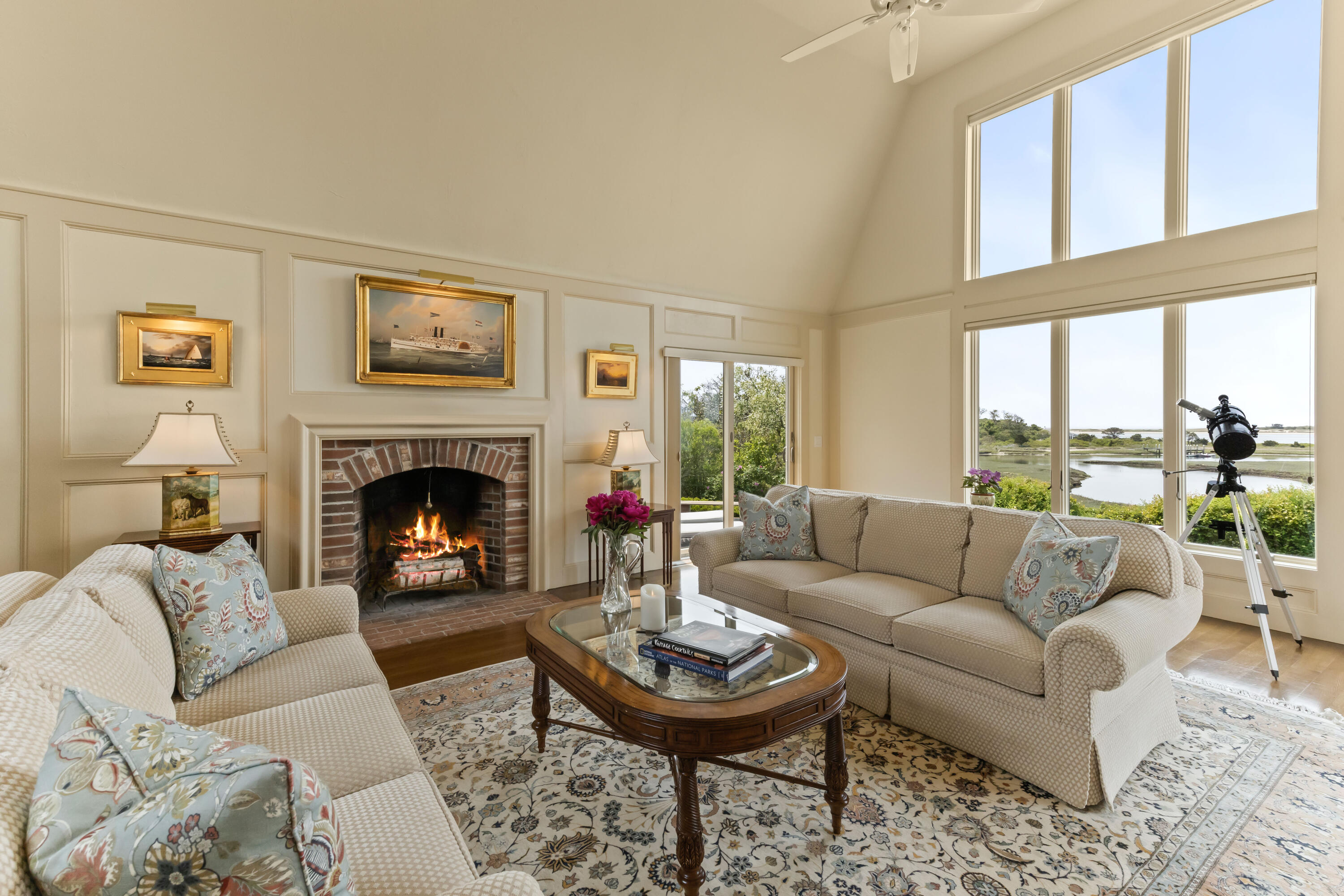 270 Stage Island Road Chatham, MA 02633 - Photo 21 of 63 a living room with furniture a rug a large window and a fireplace