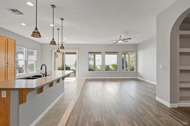 a view of a living room with hardwood floor and a ceiling fan
