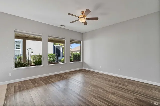 a kitchen with stainless steel appliances granite countertop a sink a stove and a wooden floors