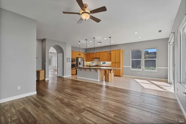 a kitchen with stainless steel appliances granite countertop a sink a stove and a refrigerator